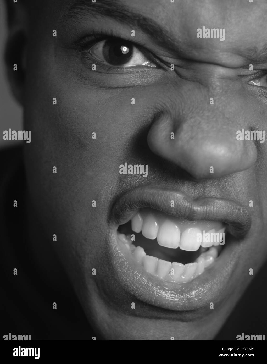 Closeup of an angry screaming man in black & white Stock Photo