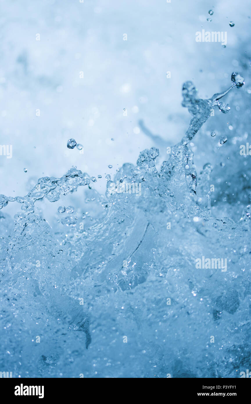 Blue water splash background from nature waterfall in rainforest