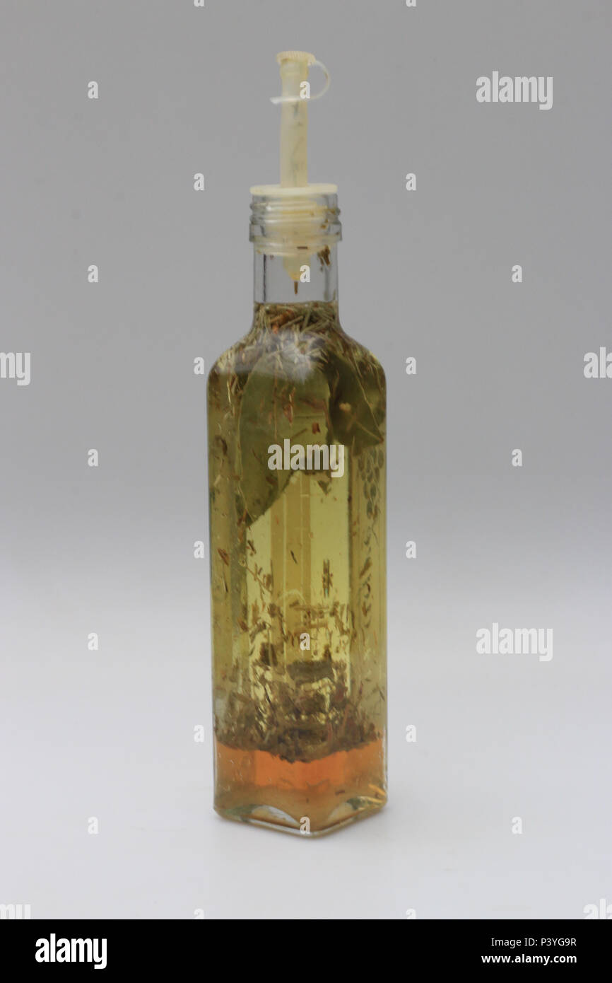 Vidro de tempero contendo ervas, azeite e vinagre. Stock Photo