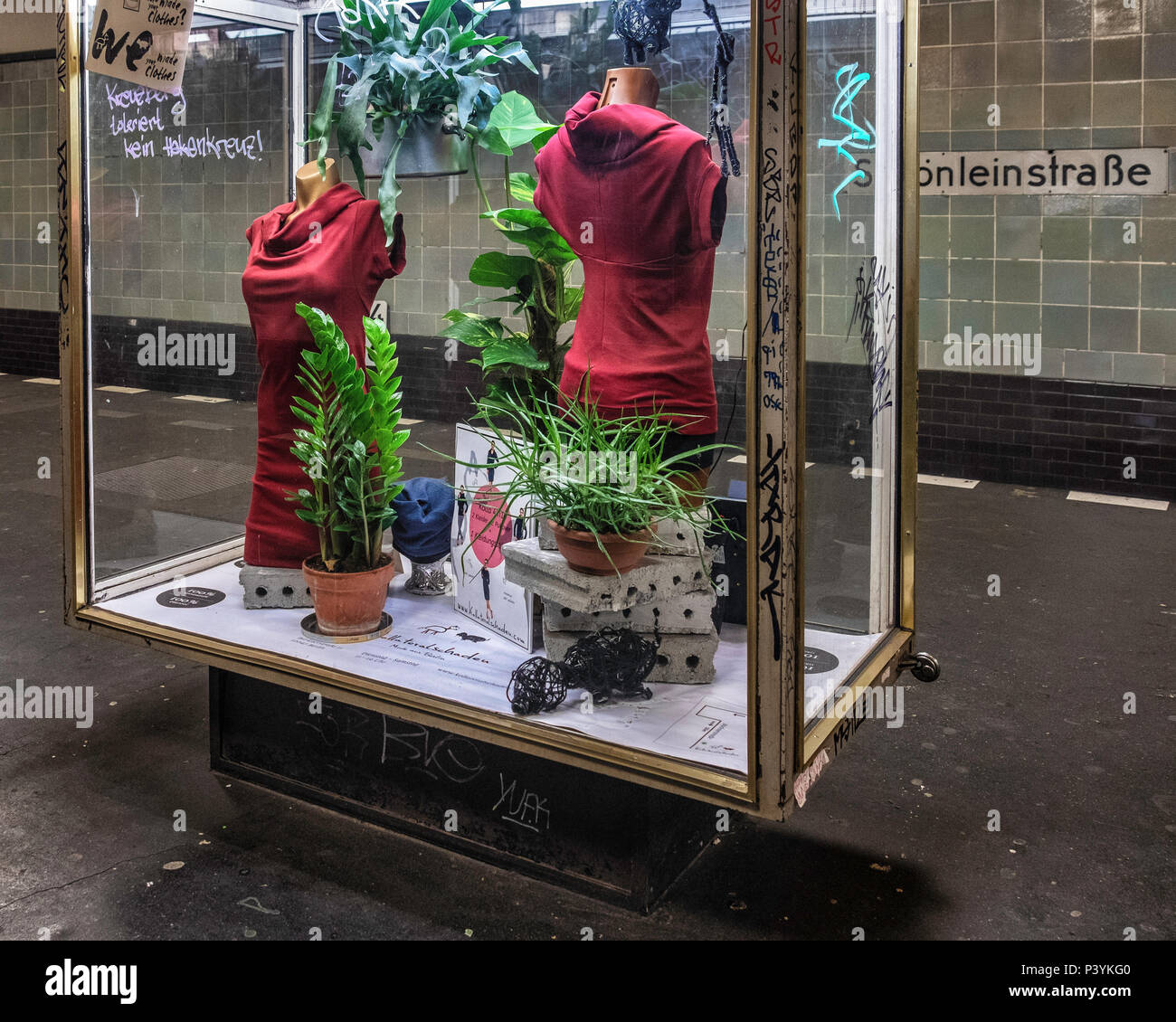 Schönleinstraße U-Bahn station . Kollateralschaden Fashion display case advtertises clothing that is ecofriendly, organic & avoids collateral damage a Stock Photo