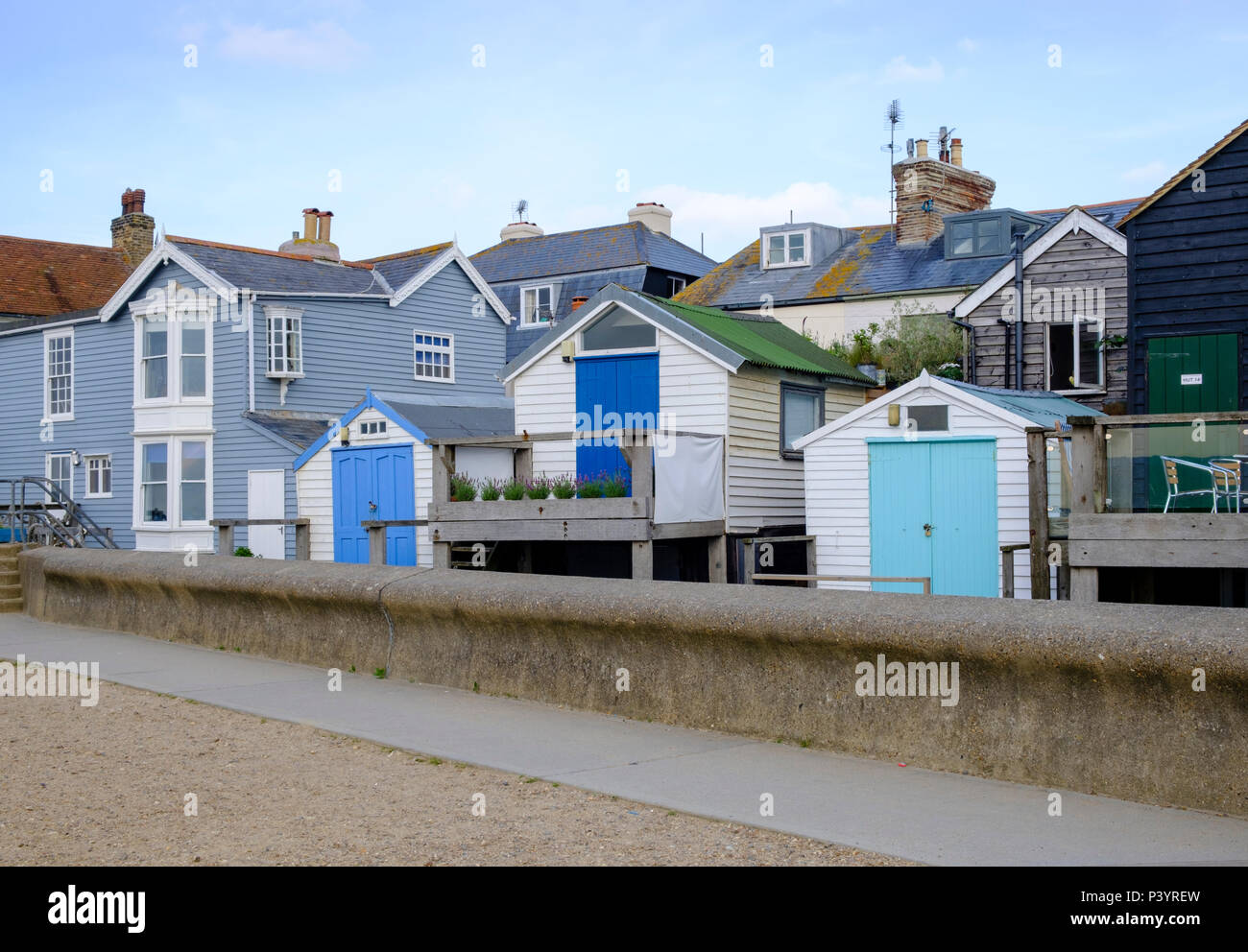 Timber clad seafront properties at Whitstable showing the protective sea wall Stock Photo Alamy