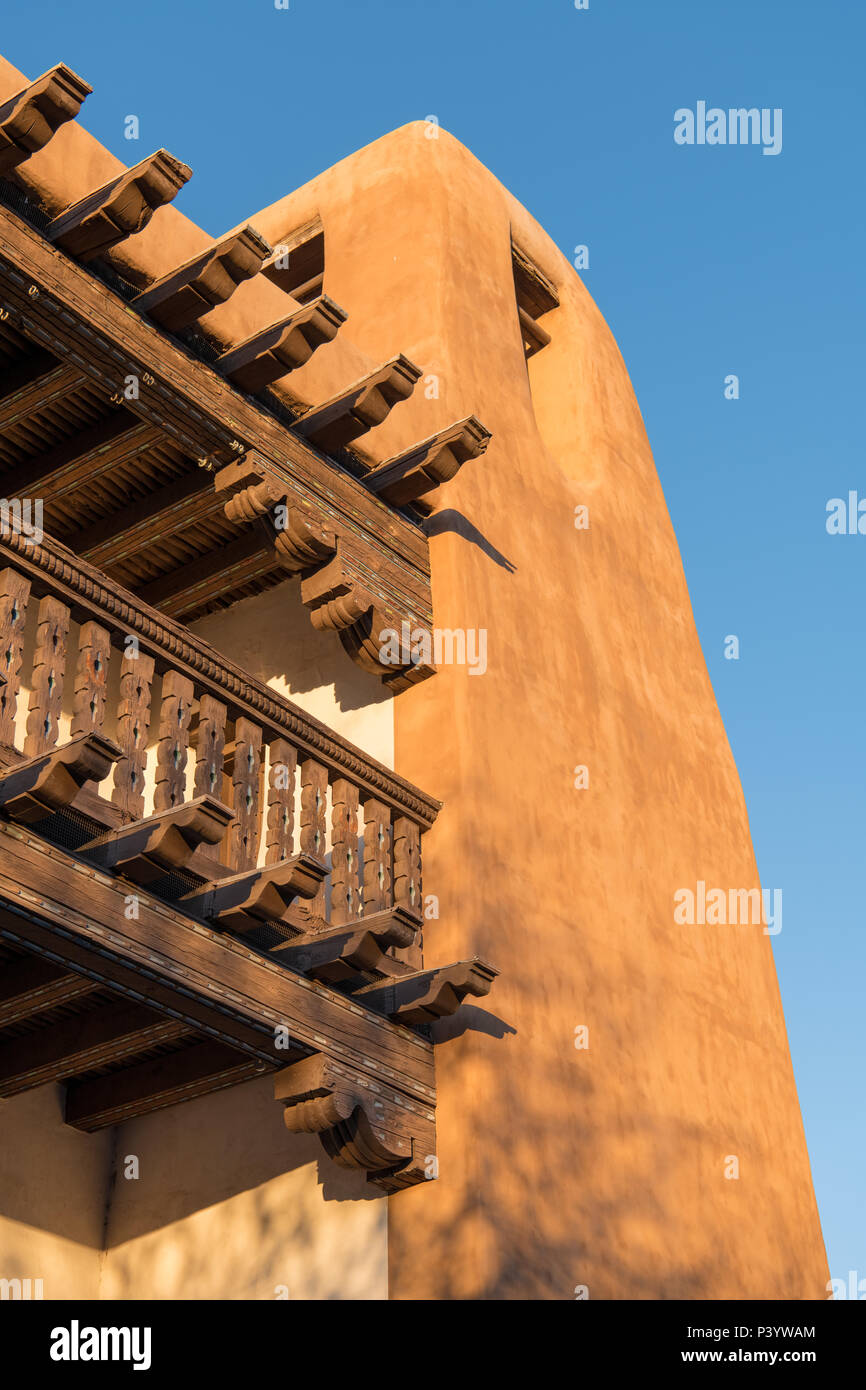 Historic adobe building with decorative wood vigas and beams and ornate woodwork in Santa Fe, New Mexico Stock Photo
