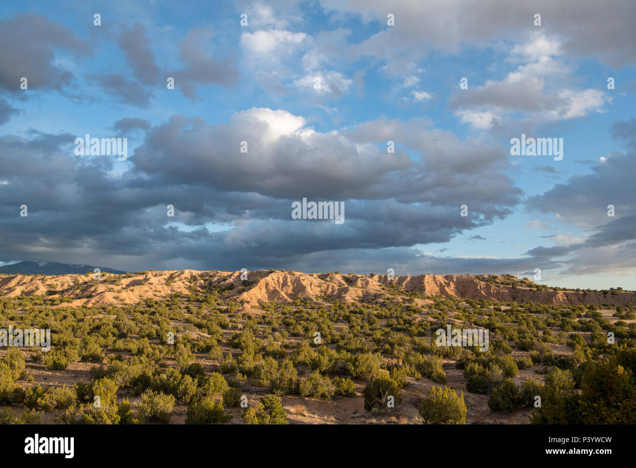 Dramatic evening sky and clouds over desert and badlands near Santa Fe, New Mexico Stock Photo