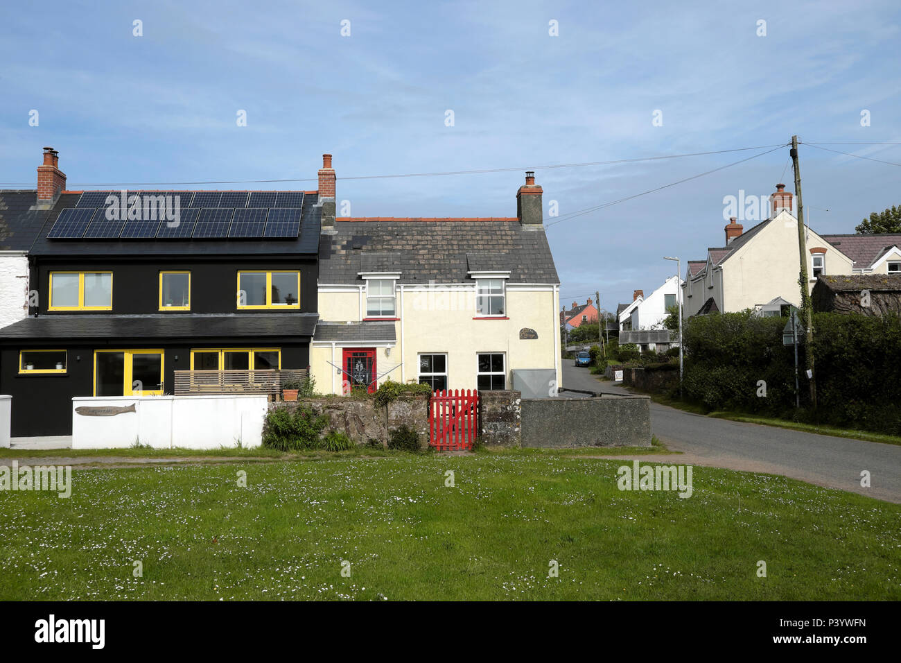 Modern House With Photovoltaic Cells And Traditional Cottage With