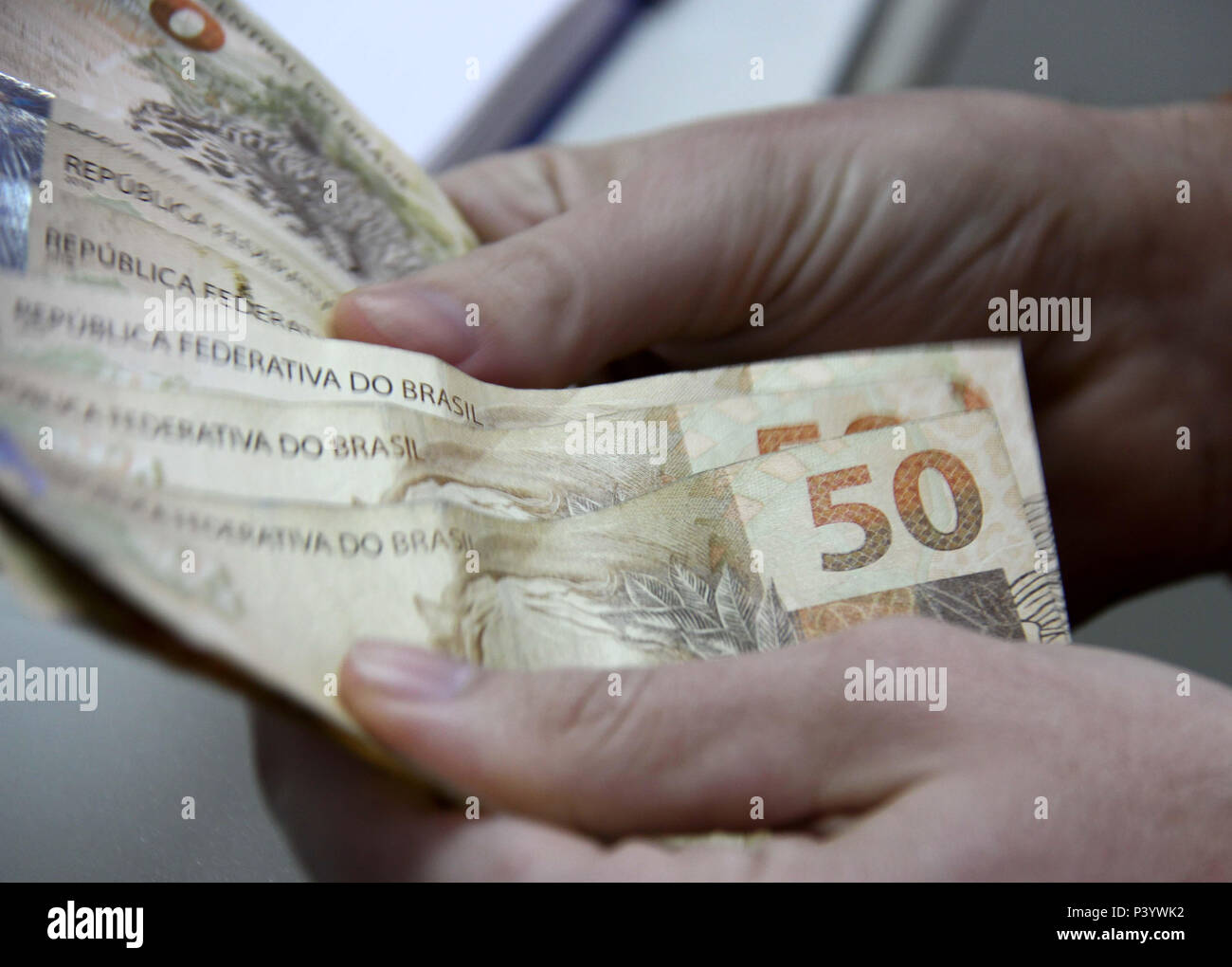 Dinheiro do Brasil, notas de Real, moeda brasileira. Na foto, homem  segurando notas de 50 reais Stock Photo - Alamy