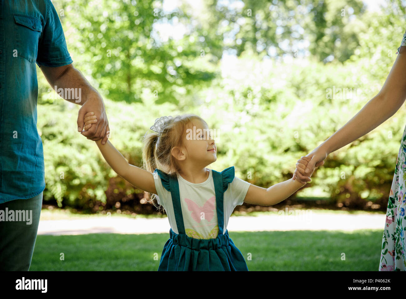 Happy young family having fun outside in spring nature Stock Photo