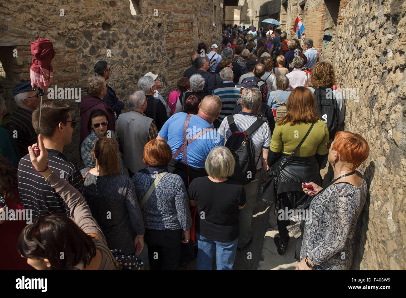 Visitors waiting in a queue to visit a lupanar (Roman brothel) in the archaeological site of Pompeii (Pompei) near Naples, Campania, Italy. Stock Photo
