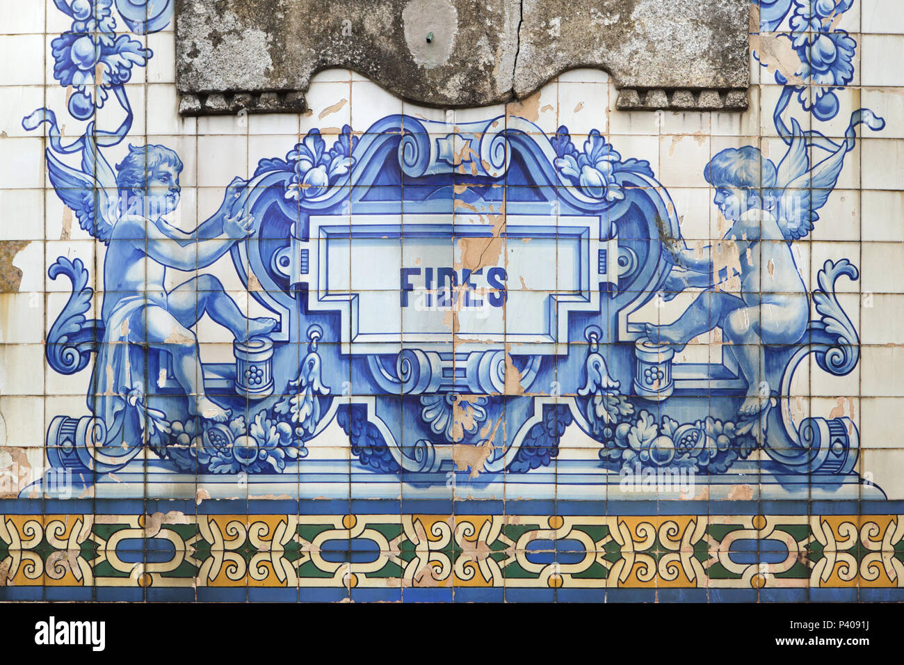 Putti depicted in the azulejo tiles painted by Portuguese painter Jorge Colaço (1932) on the main facade of the Church of Saint Ildefonso (Igreja de Santo Ildefonso) in Porto, Portugal. Fides means Faith in Latin. Stock Photo