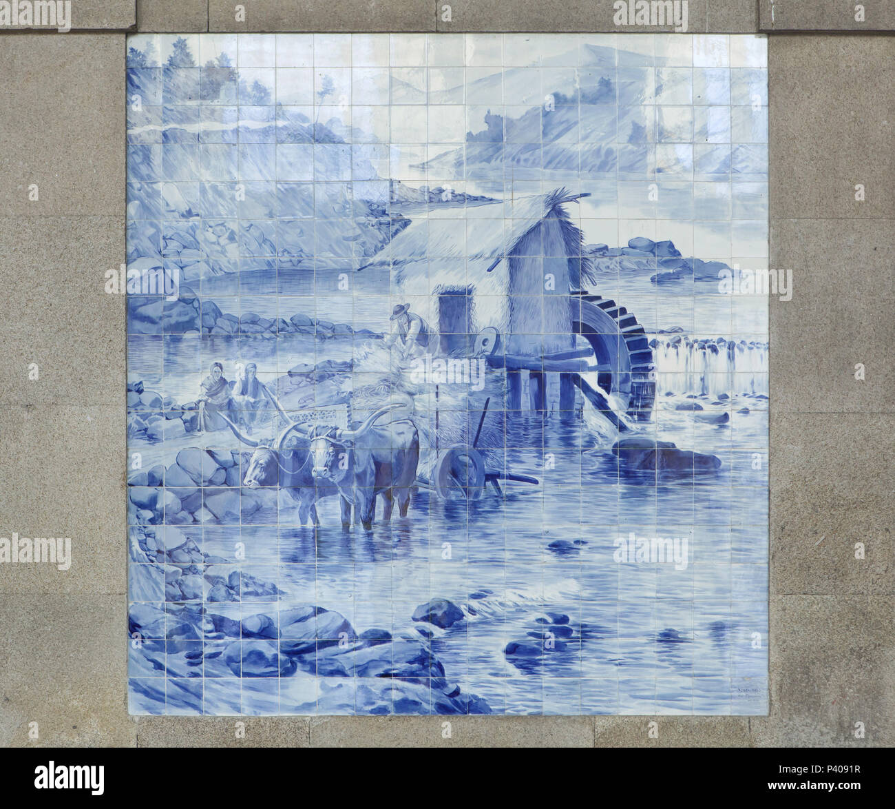 Work in the watermill depicted in the azulejo panel painted by Portuguese painter Jorge Colaço in 1905-1916 in the São Bento railway station (Estação Ferroviária de São Bento) in Porto, Portugal. Stock Photo
