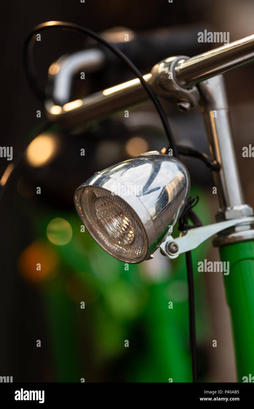 Vintage front headlamp on a green holland bicyle Stock Photo