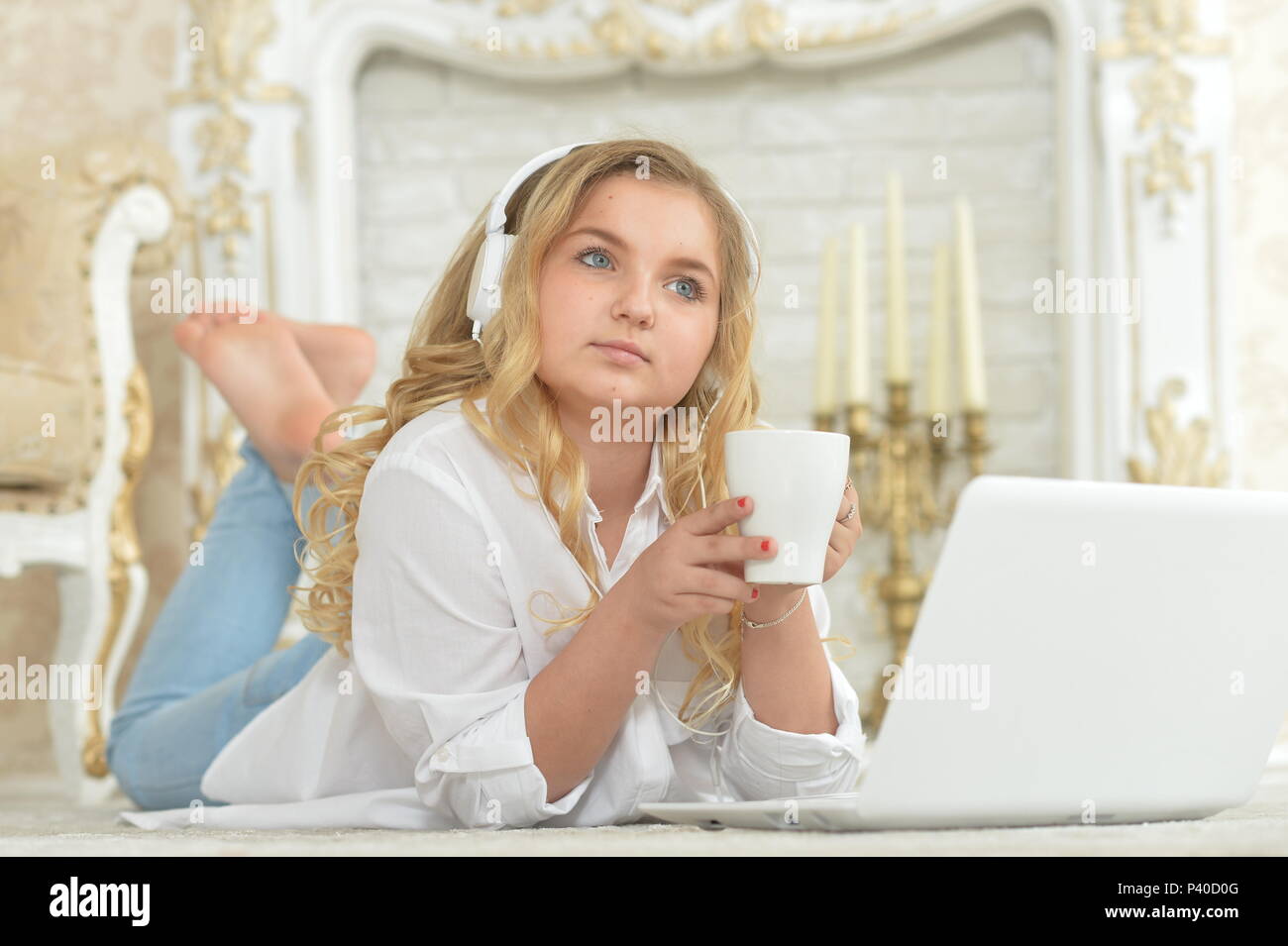 teenage girl in headphones lying on floor Stock Photo - Alamy