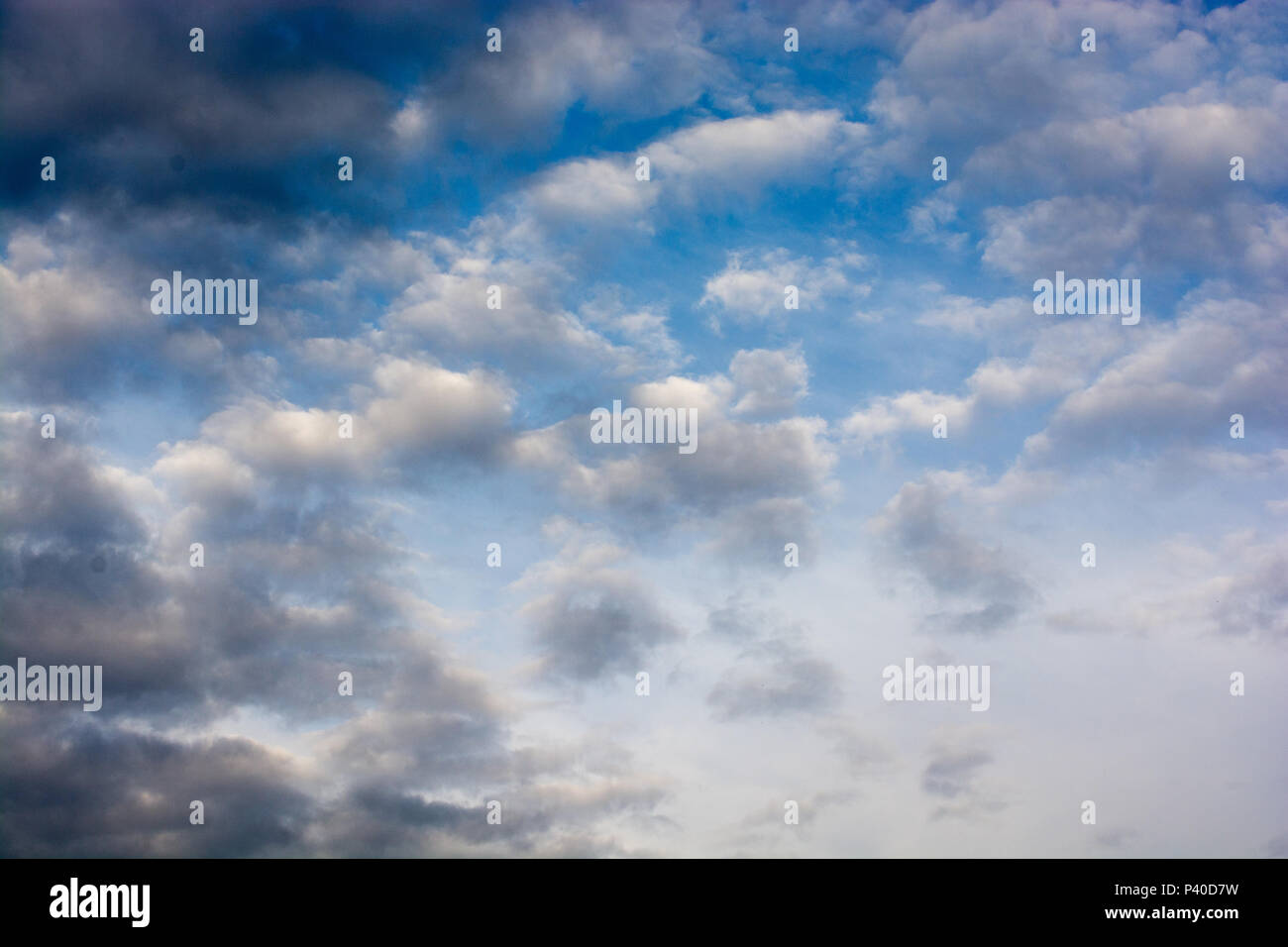Blue cloudy sky with white and grey clouds Stock Photo - Alamy