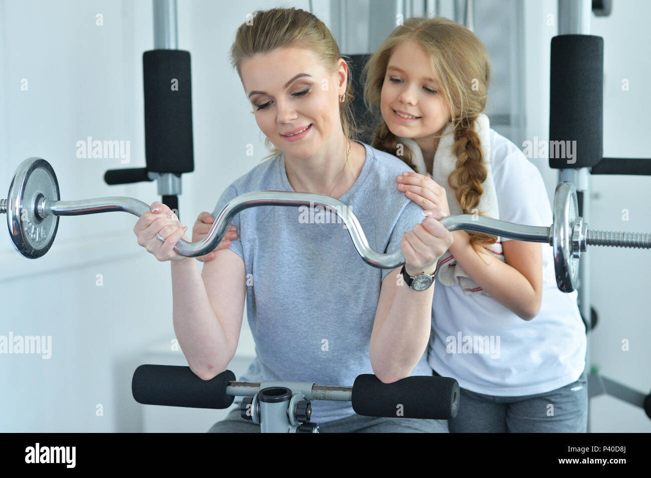 young woman training with teenage daughter Stock Photo - Alamy