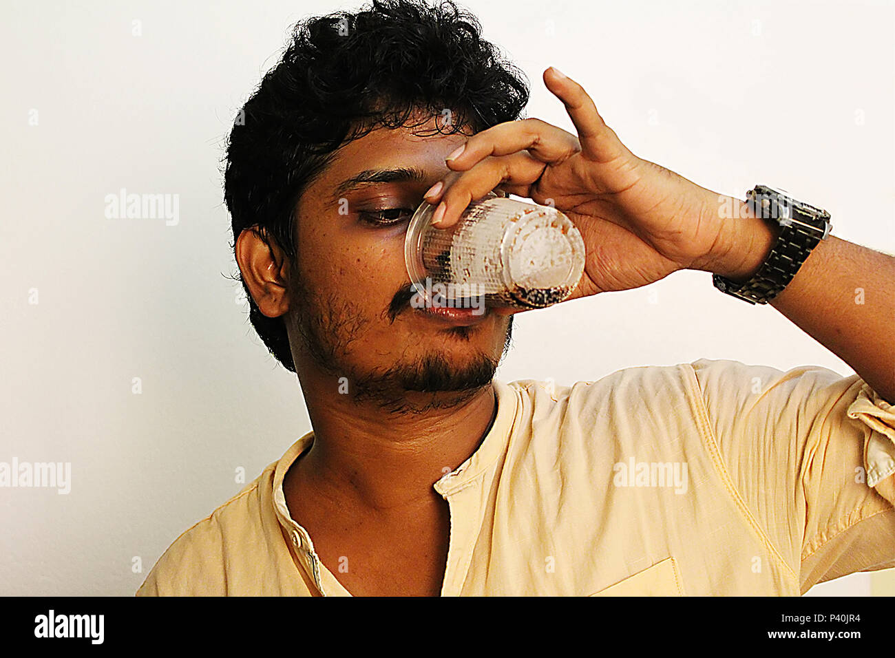 young man drinking beer or cool drinks from plastic cup Stock Photo Alamy