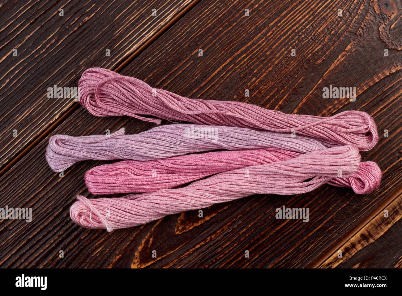 Set for pink threads for embroidery. Four bunches of embroidery threads ...