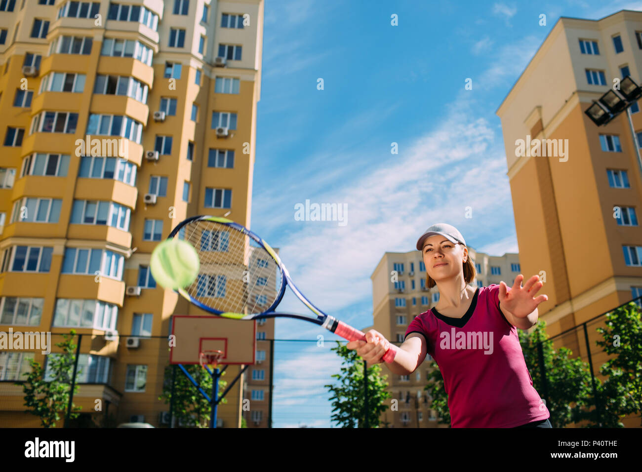 female tennis player playing tennis, hitting the ball Stock Photo