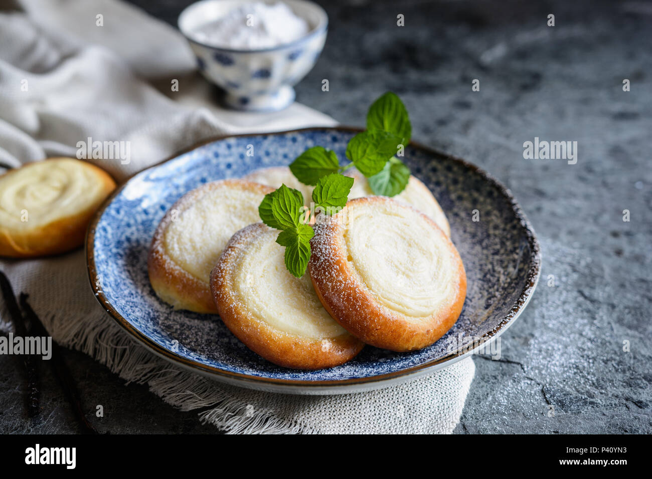 Freshly baked small round pies filled with vanilla cream cheese Stock Photo