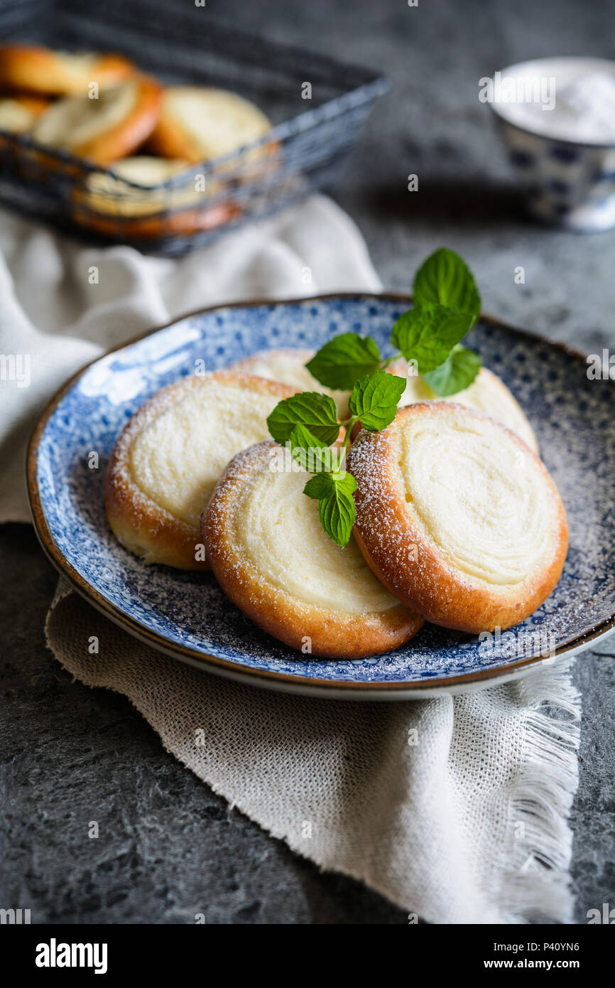 Freshly baked small round pies filled with vanilla cream cheese Stock Photo