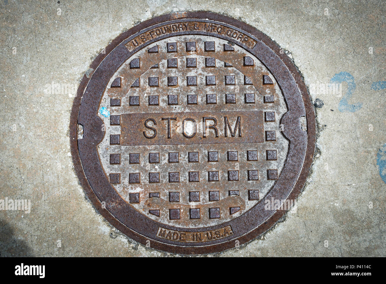 close up of a metal storm drain cover in the USA Stock Photo
