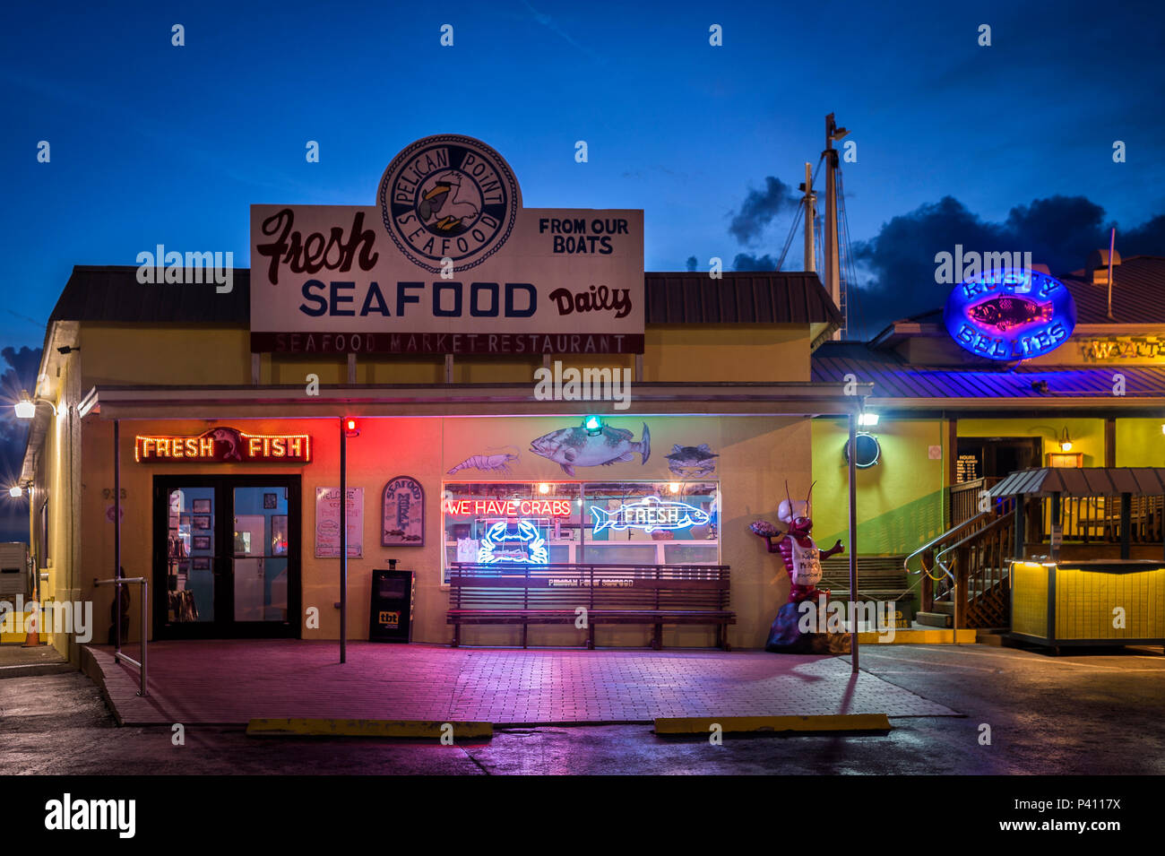 Pelican Point seafood restaurant at night with neon signs, Tarpon