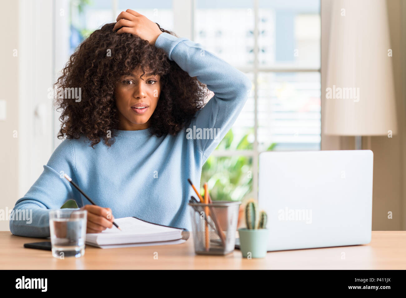 African american woman studying at home using a computer laptop ...