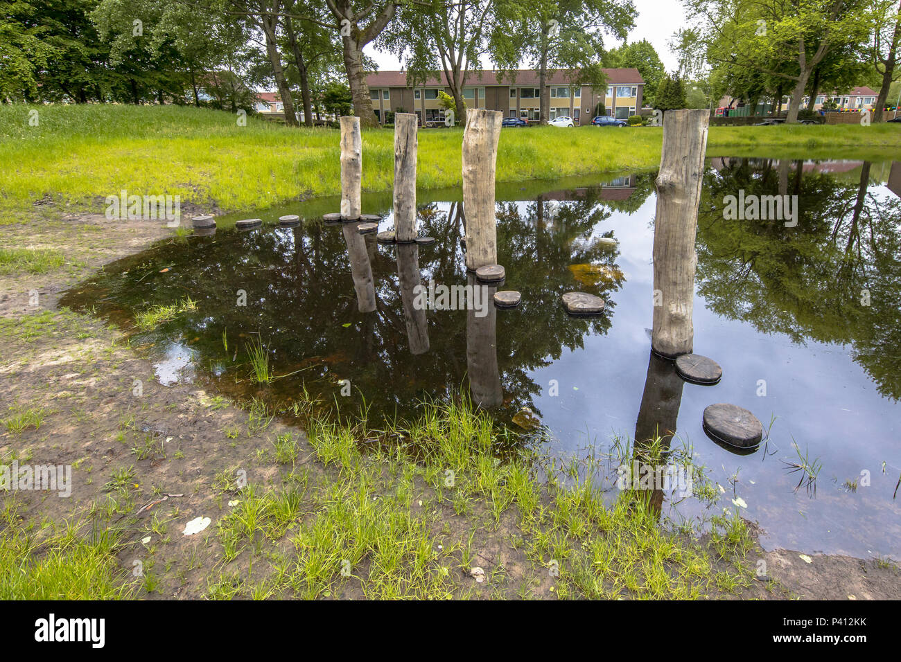 Stepping stones in a pond as part of a playground for children Stock Photo