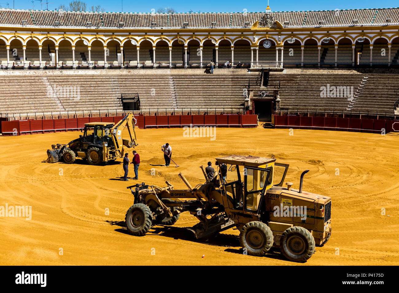 Groundsmen busy preparing Seville bullring for the next event day, Seville Stock Photo