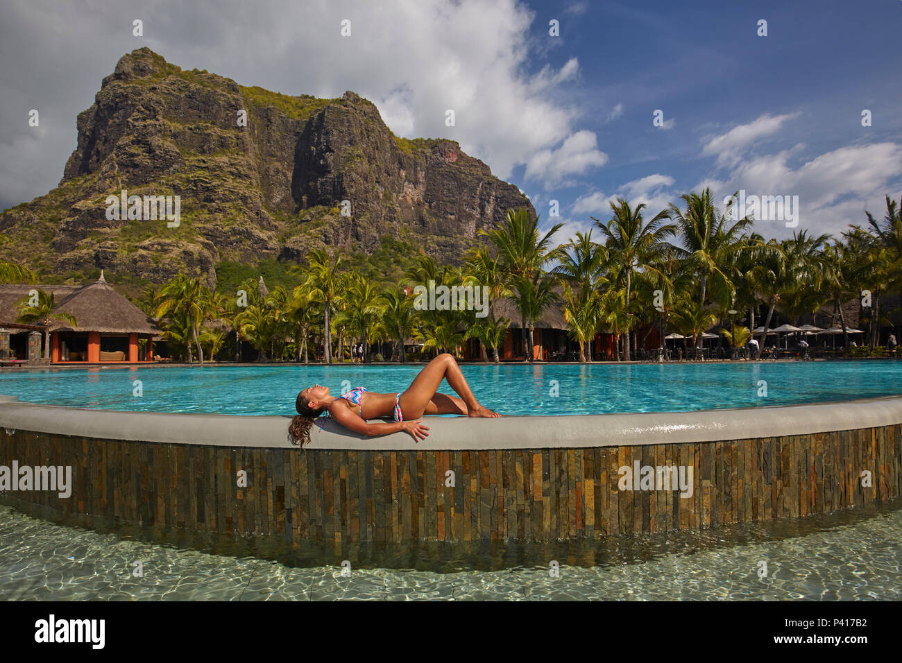 Woman in the swimming pool of Dinarobin Beachcomber at Le Morne Brabant, Mauritius Stock Photo