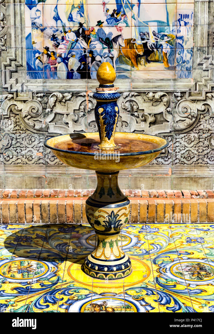 Old ceramic pedestal bowl full of water, Plaza de Espana, Andalusia, Spain. Stock Photo