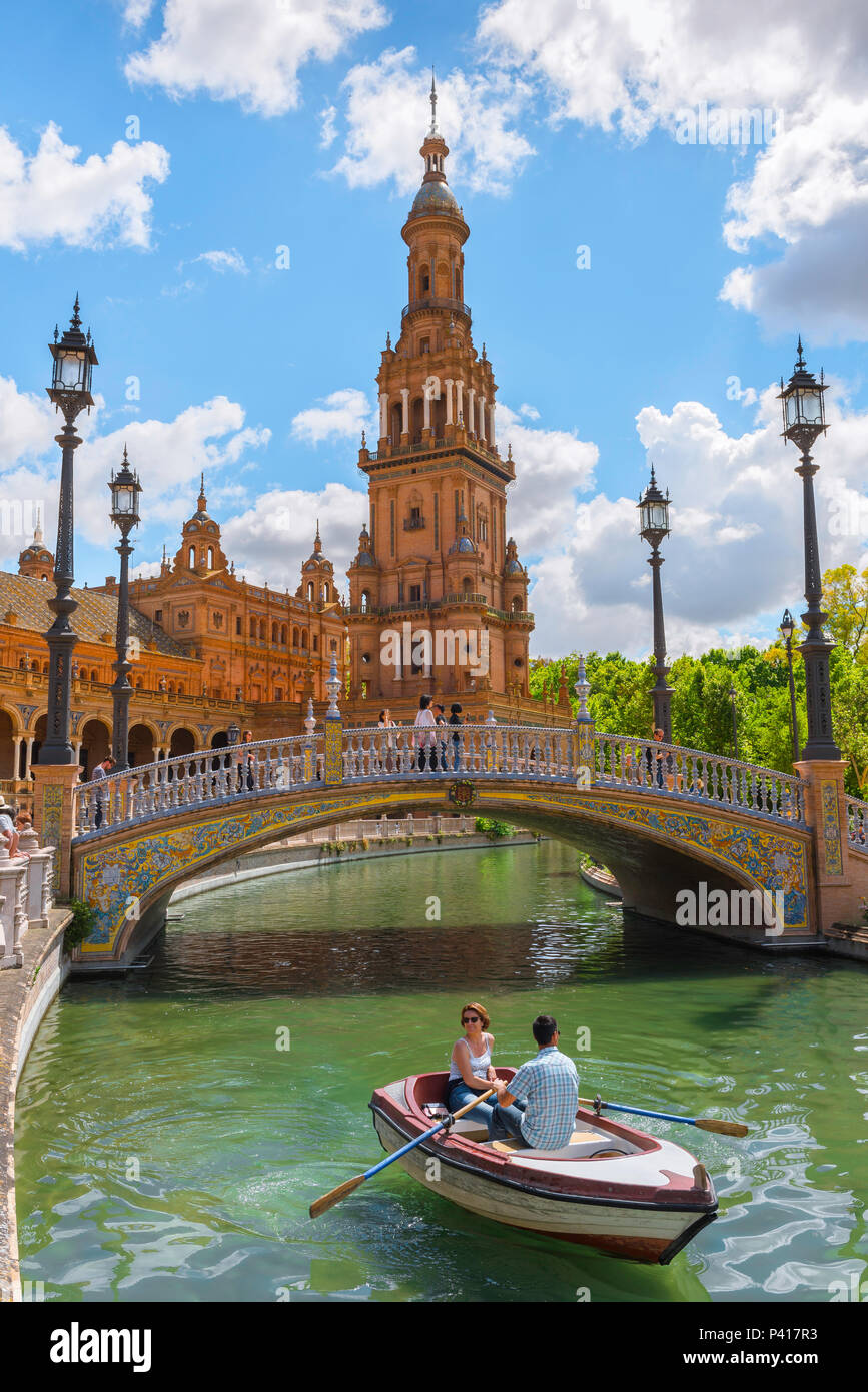 Seville Plaza de Espana, view of a couple rowing on the boating lake in the historic Plaza de Espana on a summer afternoon, Sevilla, Andalucia, Spain. Stock Photo