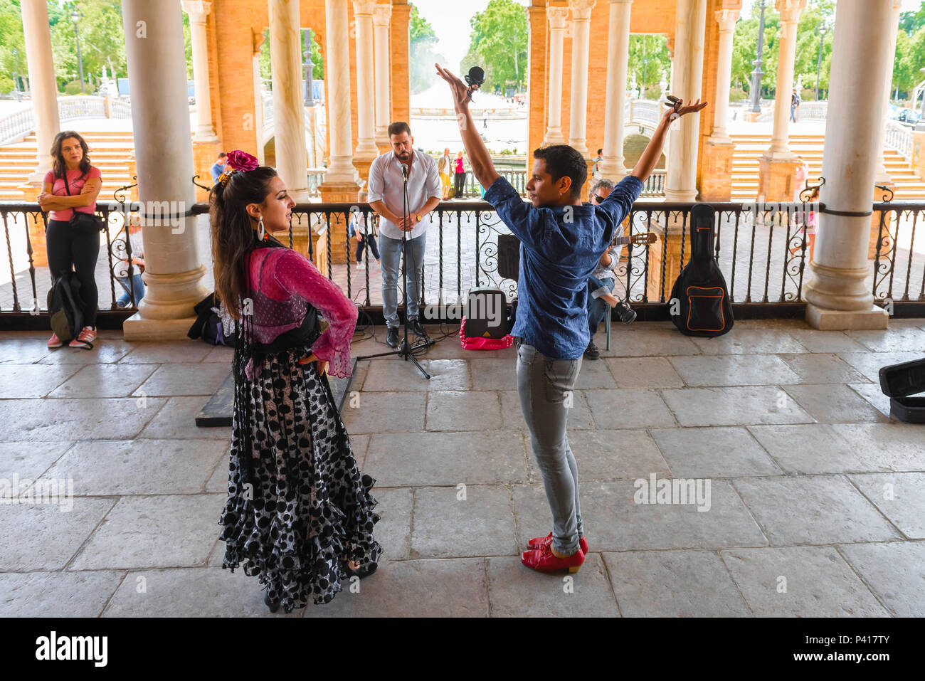 Flamenco Andalucia, two flamenco dancers perform under the colonnade in the Plaza de Espana on a summer afternoon in Seville (Sevilla), Spain. Stock Photo
