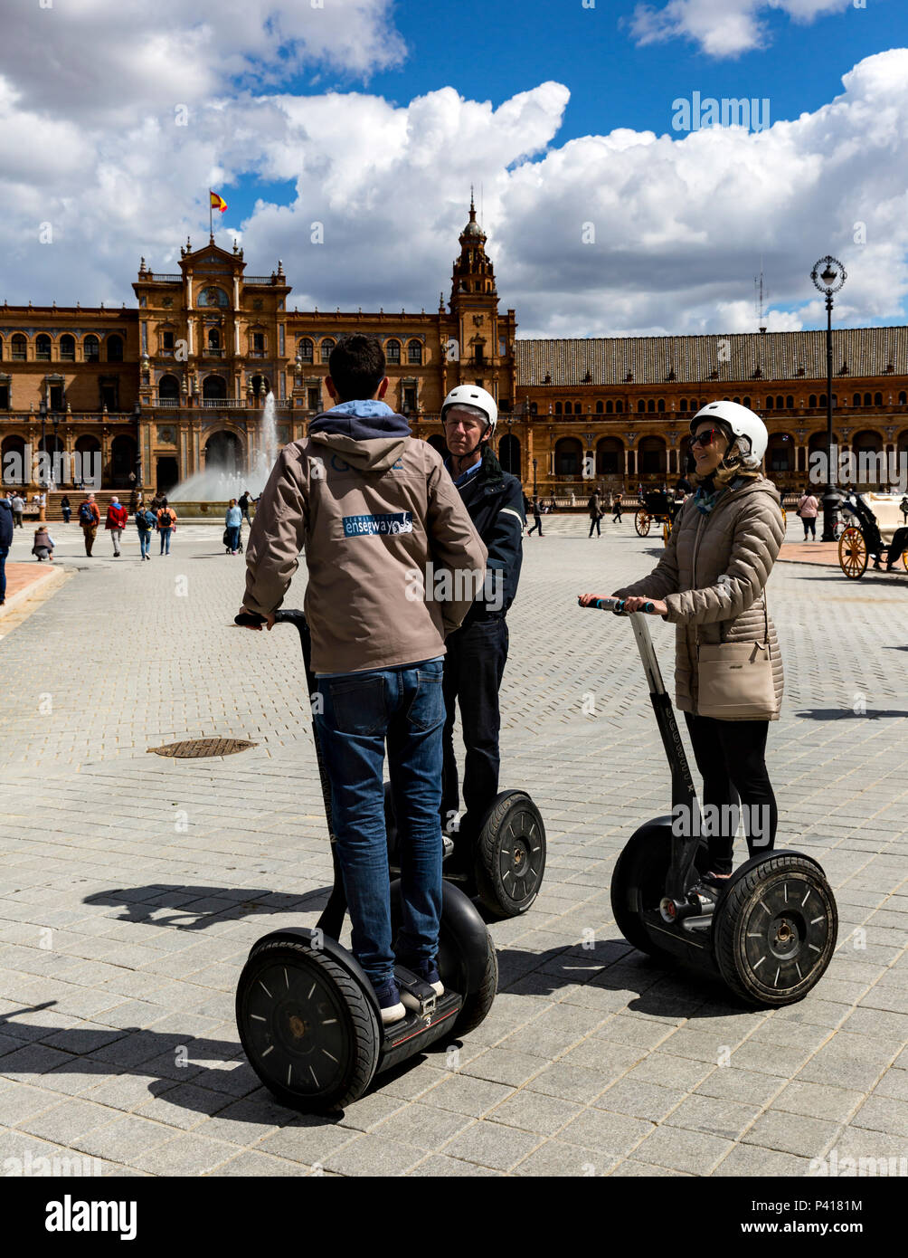 Thre tourists on Segways at Plaza de Espana, Seville, Andalusia, Spain. Stock Photo