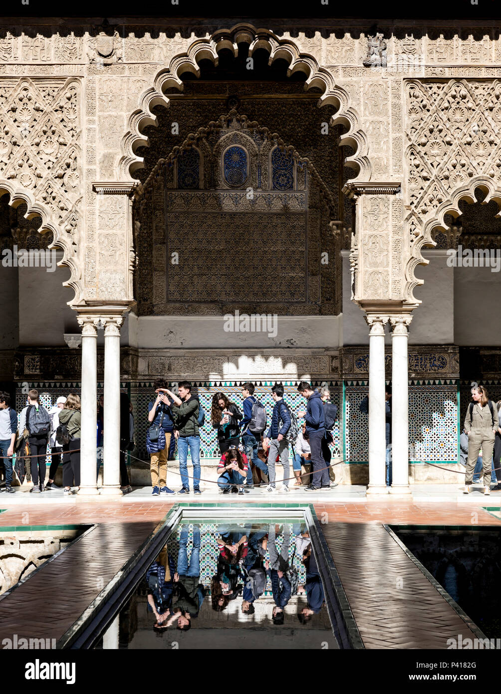 Tourists at Patio de las Doncellas courtyard, Reales Alcázares de Sevilla, Seville, Andalusia, Spain. Stock Photo