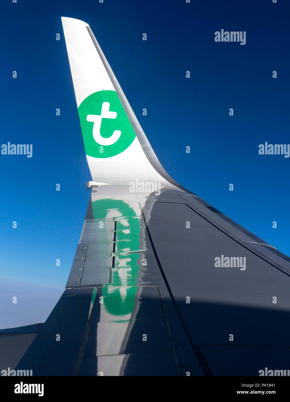 Wing of a Transavia airlines plane in flight. Stock Photo