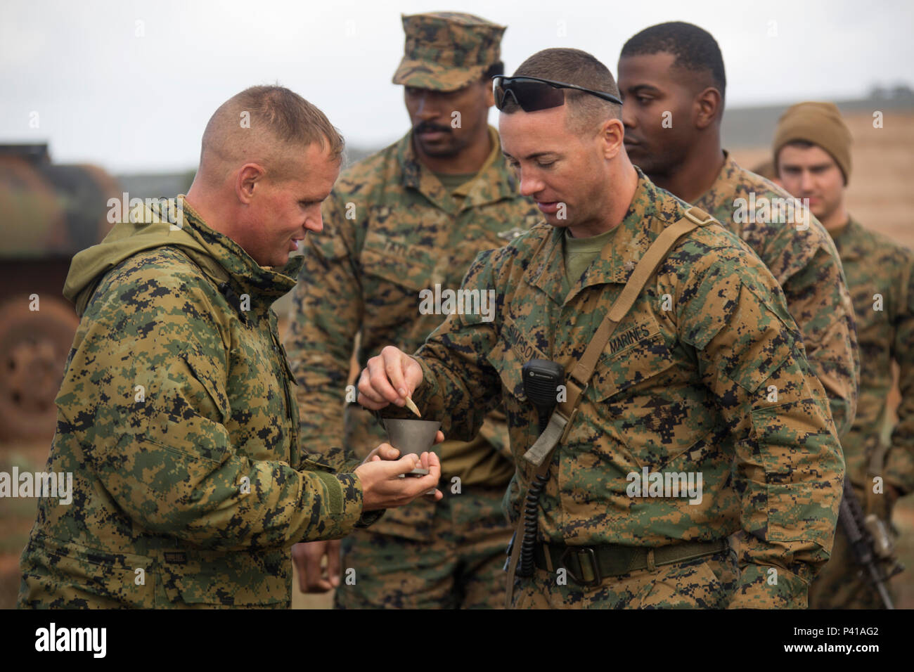 U.S. Navy Lt. Michael S. Kennedy, Marine Rotational Force – Darwin Chaplain, serves communion to Maj. Christopher W. Simpson, Company C Commander, at the Company C bivouac in Cultana Training Area,