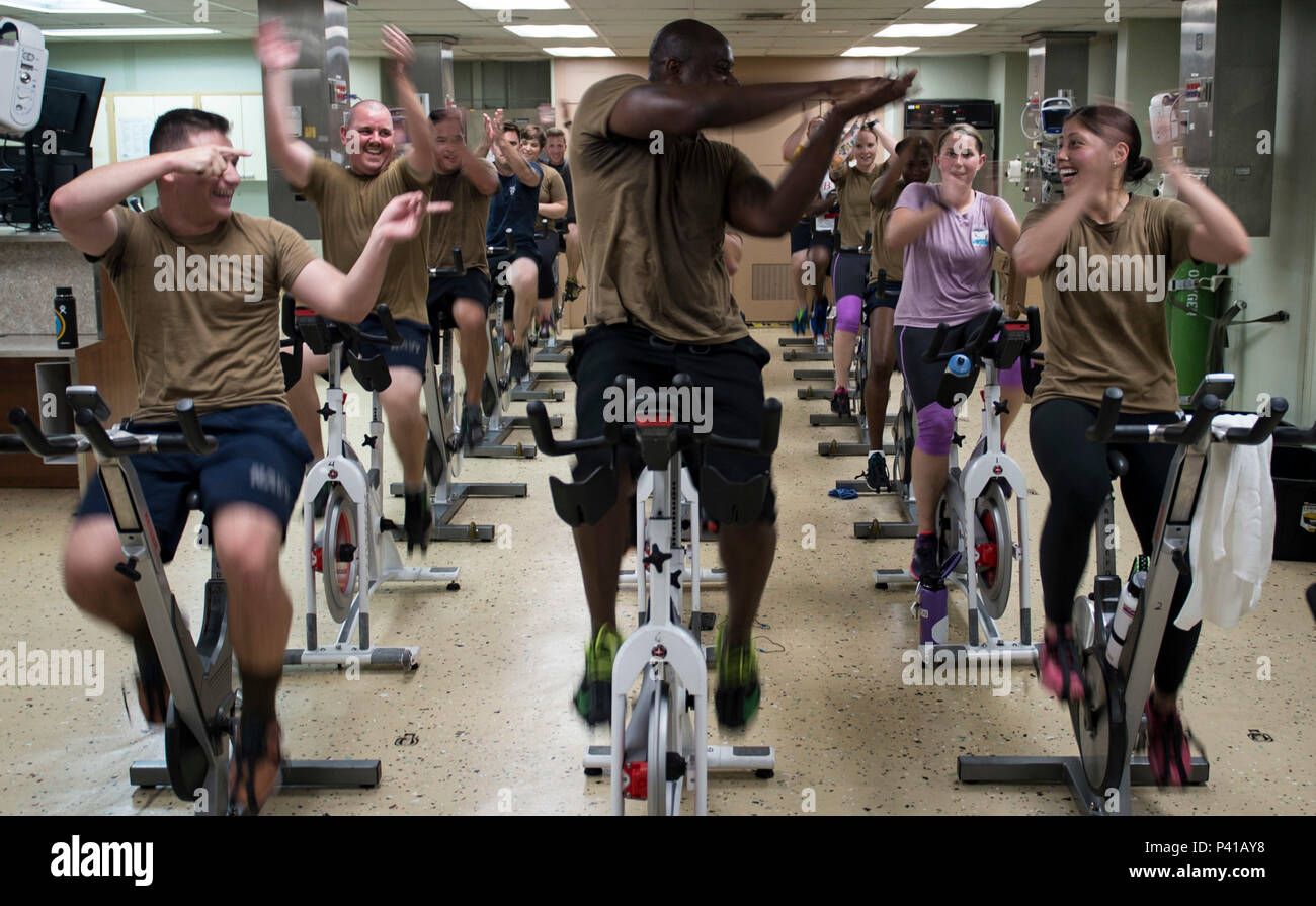 160606-N-QW941-092 PACIFIC OCEAN (June 6, 2016) Construction Electrician Constructionman Derek Drummond (center), a native of Waldorf, Maryland, leads fellow Seabees in a motivated clap during a divisional spin class aboard hospital ship USNS Mercy (T-AH 19). Deployed in support of Pacific Partnership 2016, Mercy is scheduled to visit Timor Leste, the Republic of the Philippines, Vietnam, Malaysia and Indonesia. Medical, engineering and various other personnel embarked aboard Mercy will work side-by-side with partner nation counterparts, exchanging ideas, building best practices and relationsh Stock Photo