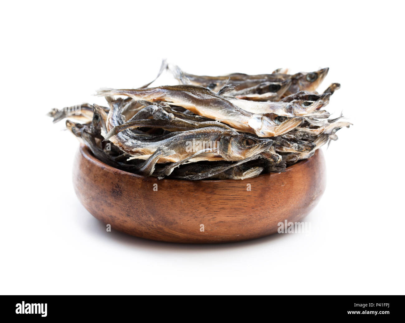 Dried fishes in wooden bowl isolated on white Stock Photo Alamy