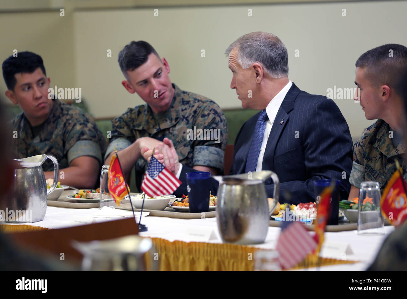 Sen. Thom Tillis, right, greets the Marines sharing a meal with him at the mess hall during a visit at Marine Corps Air Station Cherry Point, N.C., June 1, 2016. Tillis visited the air station to address the needs and priorities of the base, and assess the Marine Corps’ presence in North Carolina. Tillis also toured Fleet Readiness Center East. Tillis is a North Carolina senator. (U.S. Marine Corps photo by Lance Cpl. Mackenzie Gibson/Released) Stock Photo
