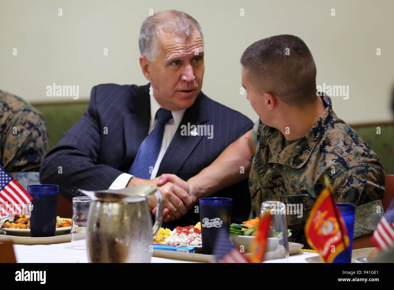 Sen. Thom Tillis, left, greets a Marine while sharing a meal at the mess hall during a visit at Marine Corps Air Station Cherry Point, N.C., June 1, 2016. Tillis visited the air station to address the needs and priorities of the base, and assess the Marine Corps’ presence in North Carolina. Tillis also toured Fleet Readiness Center East. Tillis is a North Carolina senator. (U.S. Marine Corps photo by Lance Cpl. Mackenzie Gibson/Released) Stock Photo