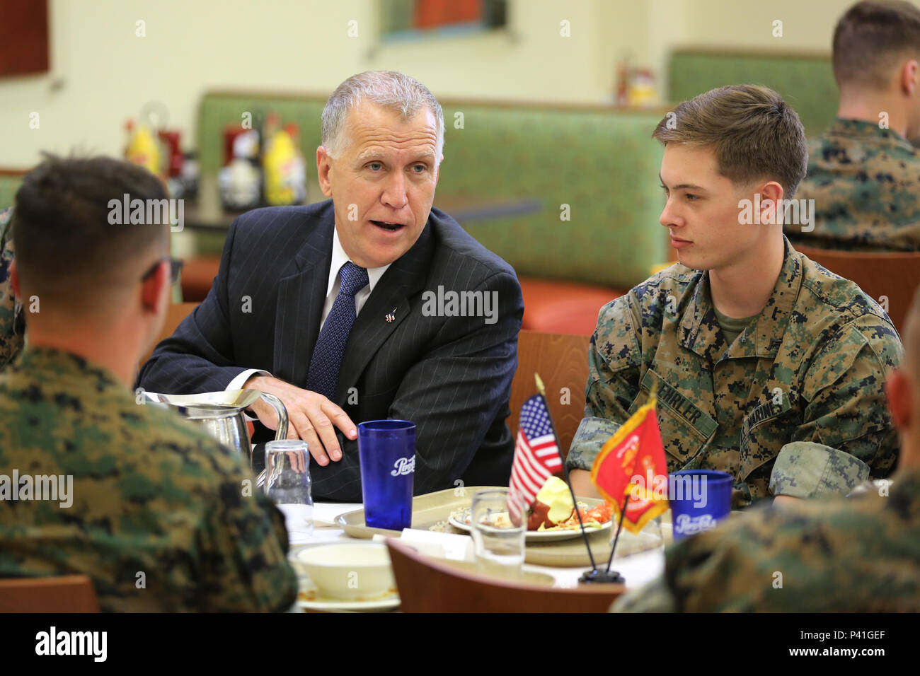 Sen. Thom Tillis shares a meal with Marines at the mess hall during a visit at Marine Corps Air Station Cherry Point, N.C., June 1, 2016. Tillis visited the air station to address the needs and priorities of the base, and assess the Marine Corps’ presence in North Carolina. Tillis also toured Fleet Readiness Center East. Tillis is a North Carolina senator. (U.S. Marine Corps photo by Lance Cpl. Mackenzie Gibson/Released) Stock Photo