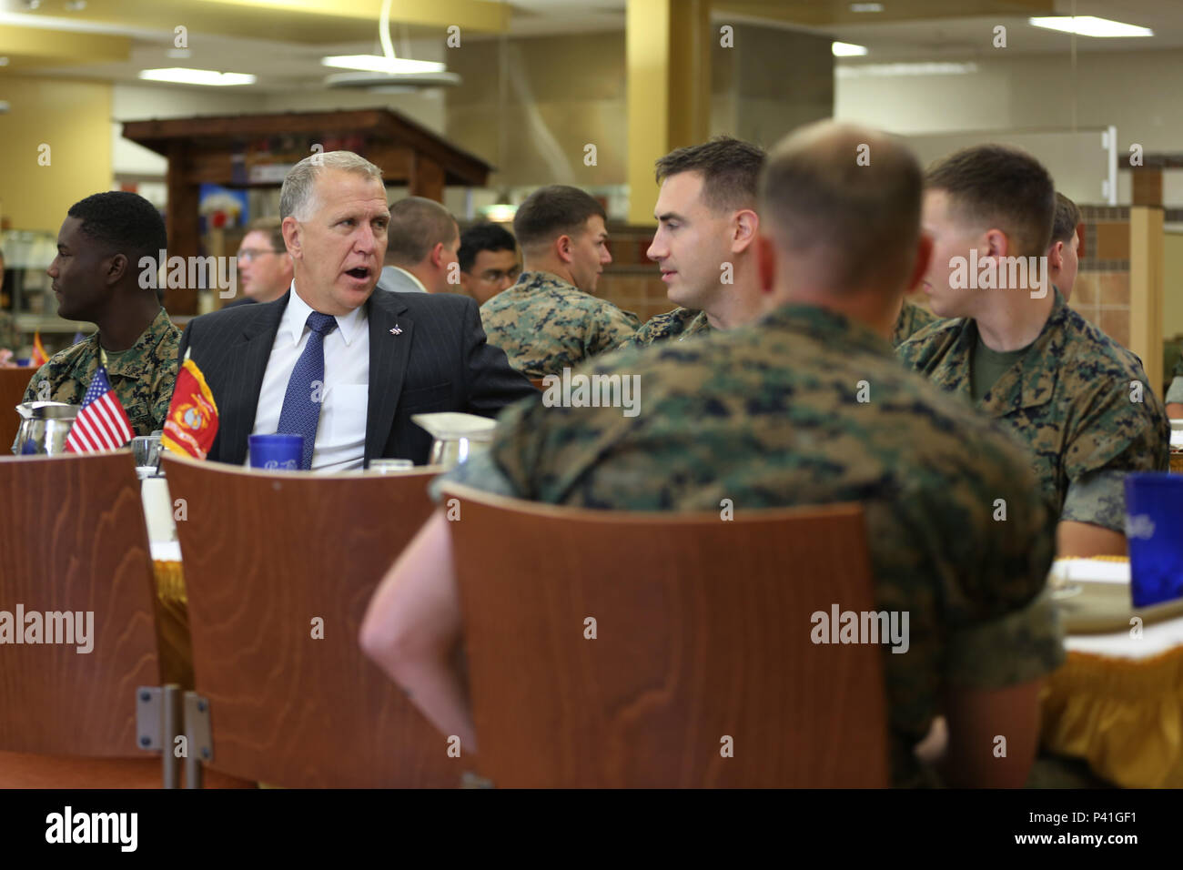 Sen. Thom Tillis, left, shares a meal with Marines at the mess hall during a visit at Marine Corps Air Station Cherry Point, N.C., June 1, 2016. Tillis visited the air station to address the needs and priorities of the base, and assess the Marine Corps’ presence in North Carolina. Tillis also toured Fleet Readiness Center East. Tillis is a North Carolina senator. (U.S. Marine Corps photo by Lance Cpl. Mackenzie Gibson/Released) Stock Photo