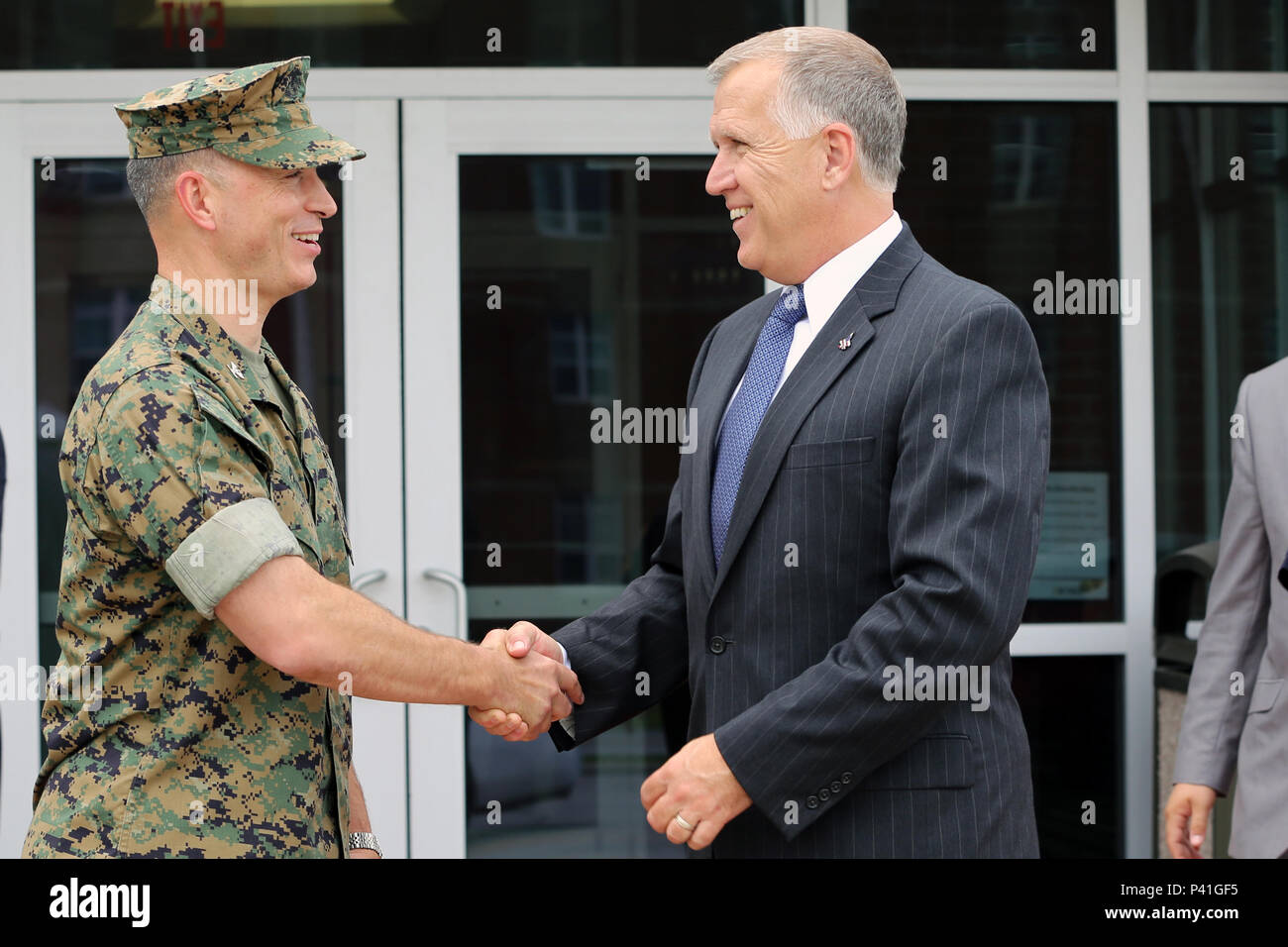 Col. Chris Pappas III, left, shakes hands with Sen. Thom Tillis at the mess hall during a visit at Marine Corps Air Station Cherry Point, N.C., June 1, 2016. Tillis visited the air station to address the needs and priorities of the base, and assess the Marine Corps’ presence in North Carolina. Tillis also toured Fleet Readiness Center East. Pappas is the commanding officer of MCAS Cherry Point, and Tillis is a North Carolina senator. (U.S. Marine Corps photo by Lance Cpl. Mackenzie Gibson/Released) Stock Photo