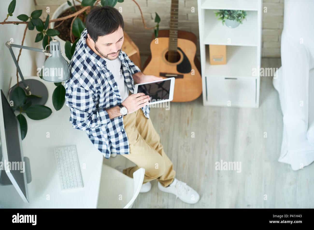 Creative man with tablet in studio Stock Photo