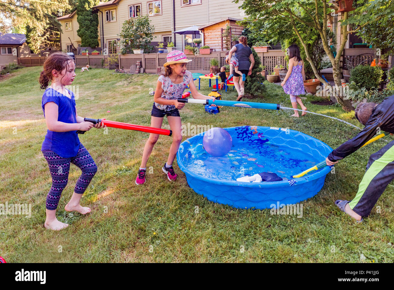 Keeping Cool Summer Fun Kids Have Friendly Backyard Water Fight Stock Photo Alamy