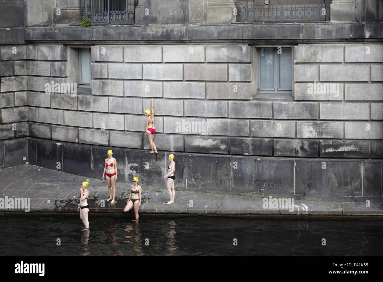 Berlin, Germany, women promote bikinis and the use of Kupfergrabens as Flussbadeanstalt at the Bode Museum Stock Photo