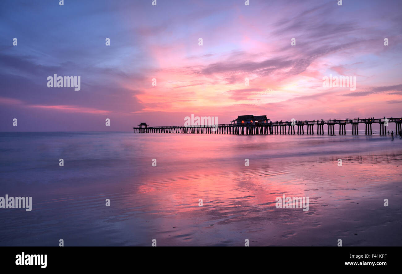 Pink and purple sunset over the Naples Pier in summer in Naples ...