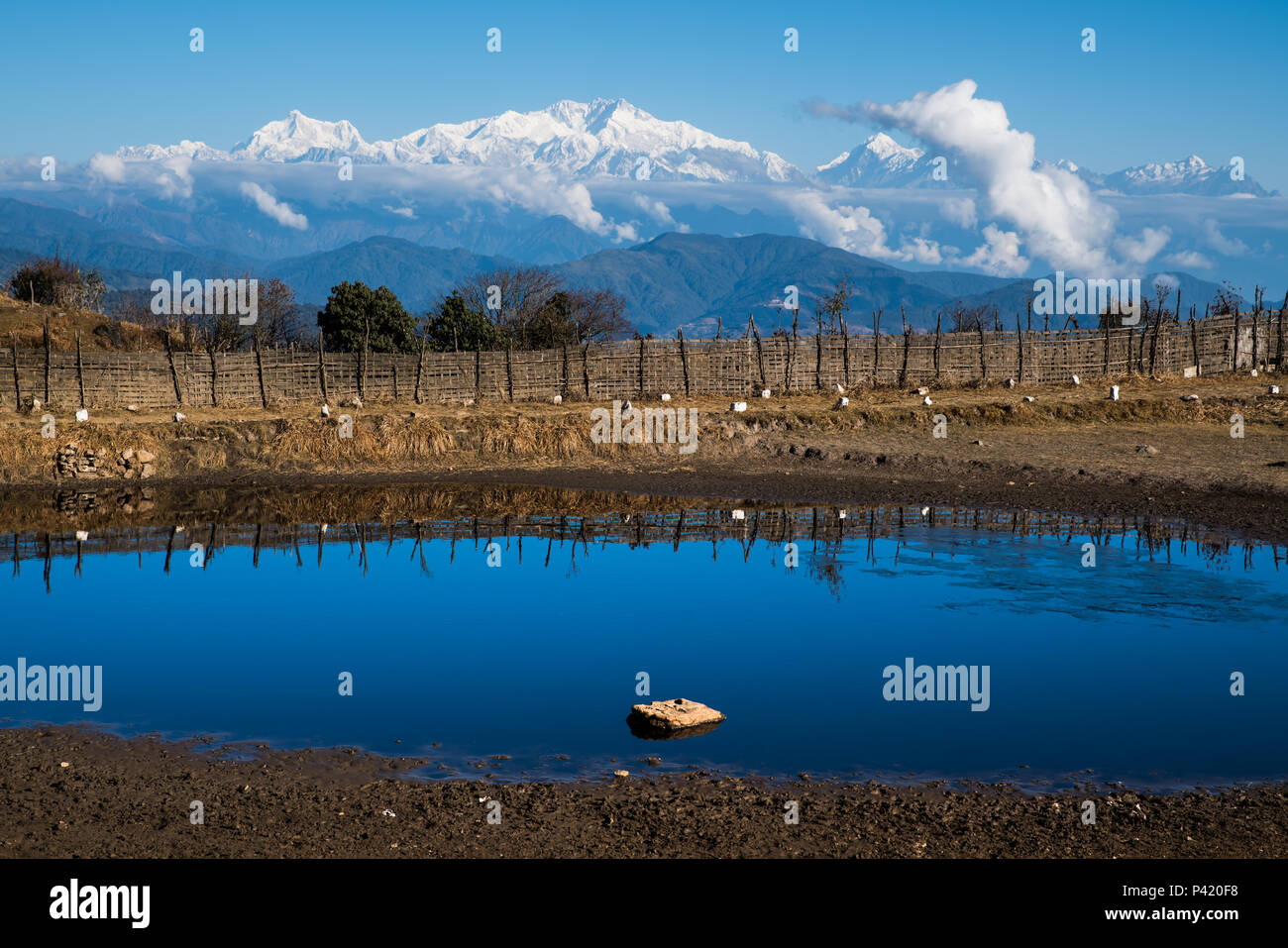 landscape of Tonglu trekkers hut and Kangchenjunga mount during blue sky day time. This place is  middle way to Sandakphu, north of India Stock Photo