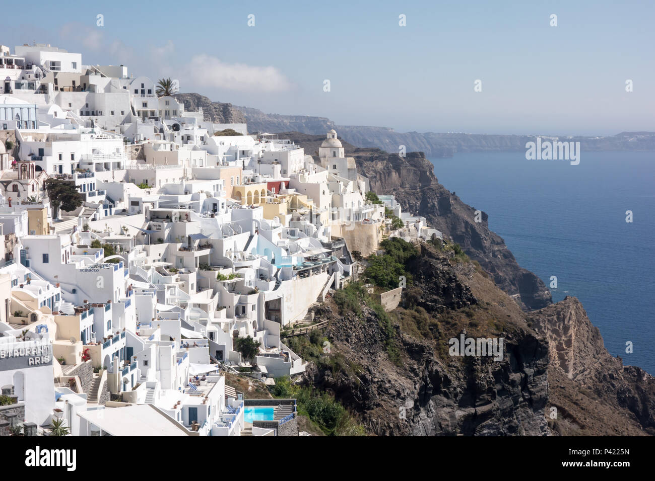 SANTORNI, GREECE - 14th May 2018: Traditional white houses of Thira that overlooks the Mediterranean Sea. Stock Photo
