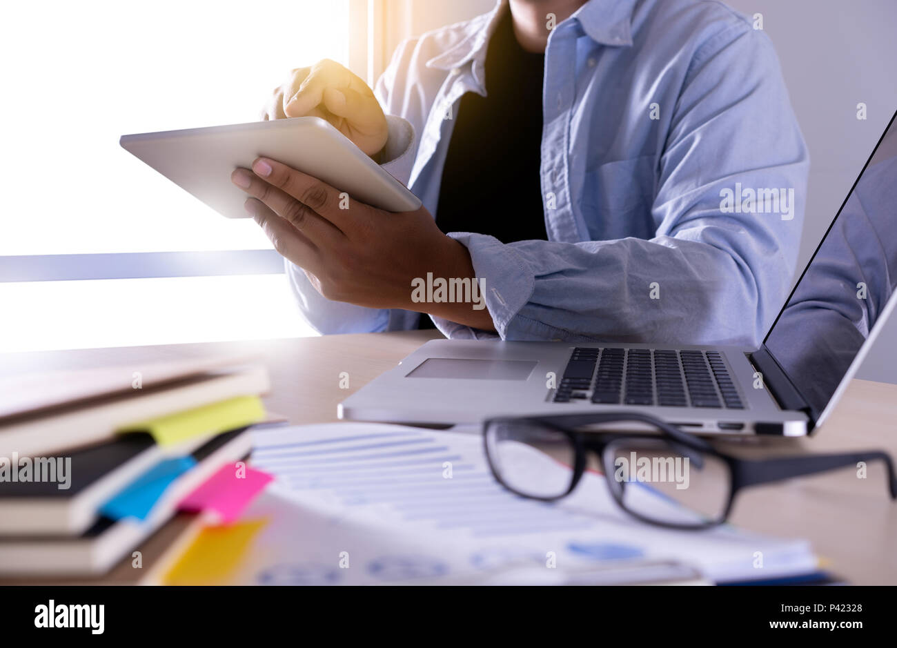 businessman using phone smart phone and notebook computer Stock Photo