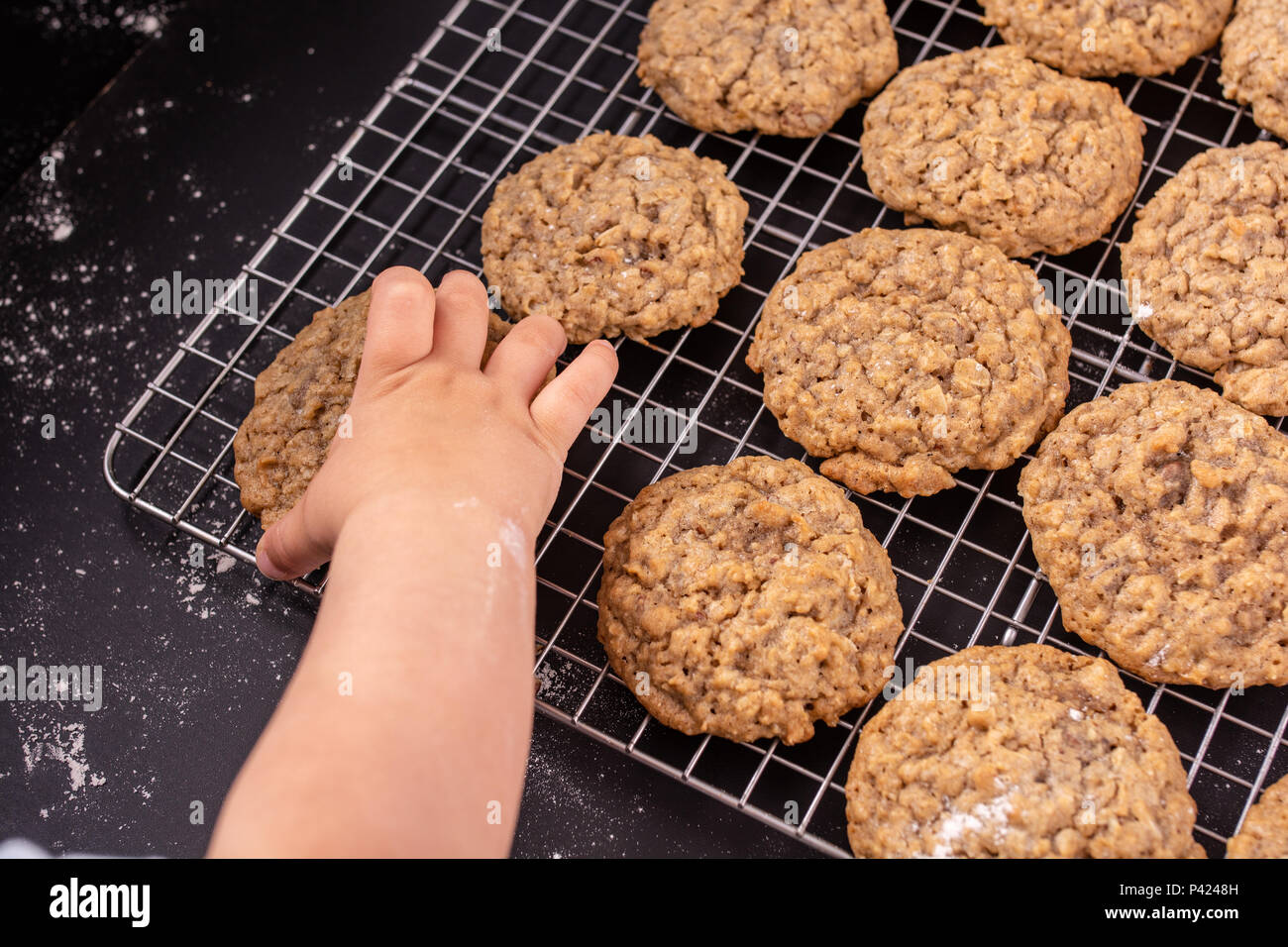 Toddler taking cookie Stock Photo - Alamy